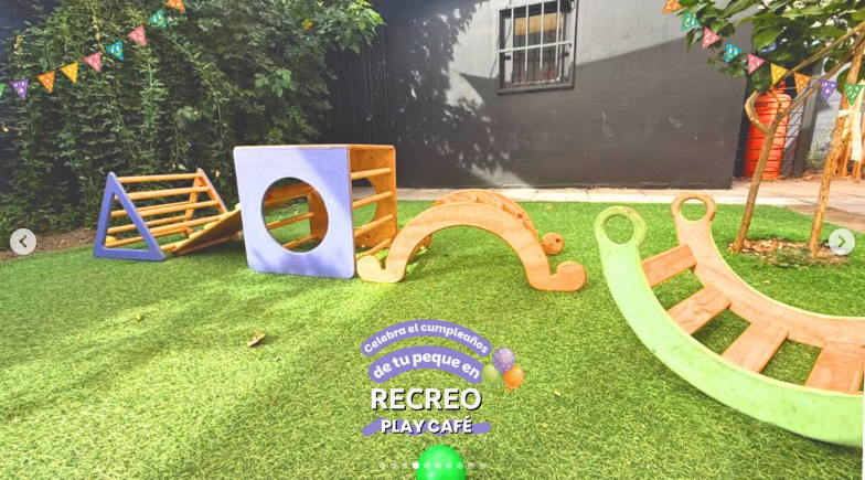 Patio exterior con módulos de equilibrio y juegos de madera sobre el pasto